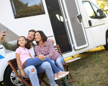 Family outside of an RV