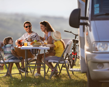 Family eating outside of an RV