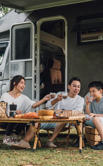 Family outside of an RV